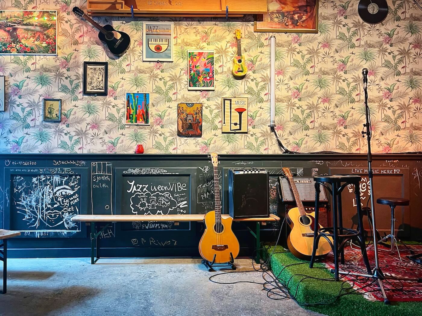 Café de Tuin: muur met gitaar en podium